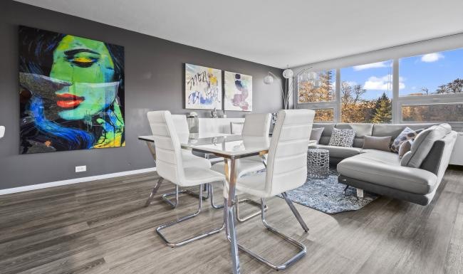 a room with a table chairs and a tv